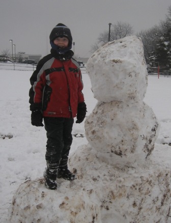 Evan with snowman  Feb. 2010